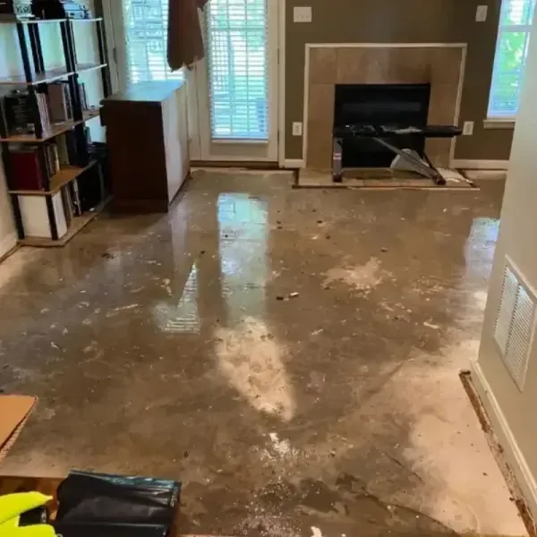 Wet concrete and removed finishes across a living room floor