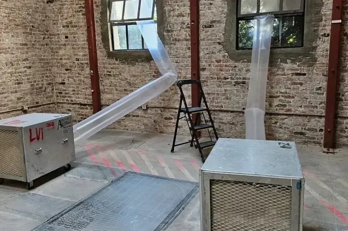 Dehumidifiers and flexible ducting set up inside a commercial space
